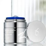 Growth Factor Serum inside a silver container next to its cover