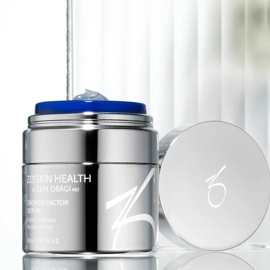 Growth Factor Serum inside a silver container next to its cover